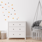 Blossom Confetti wall decals spread across a kids’ room wall featuring mixed floral shapes and black dots.