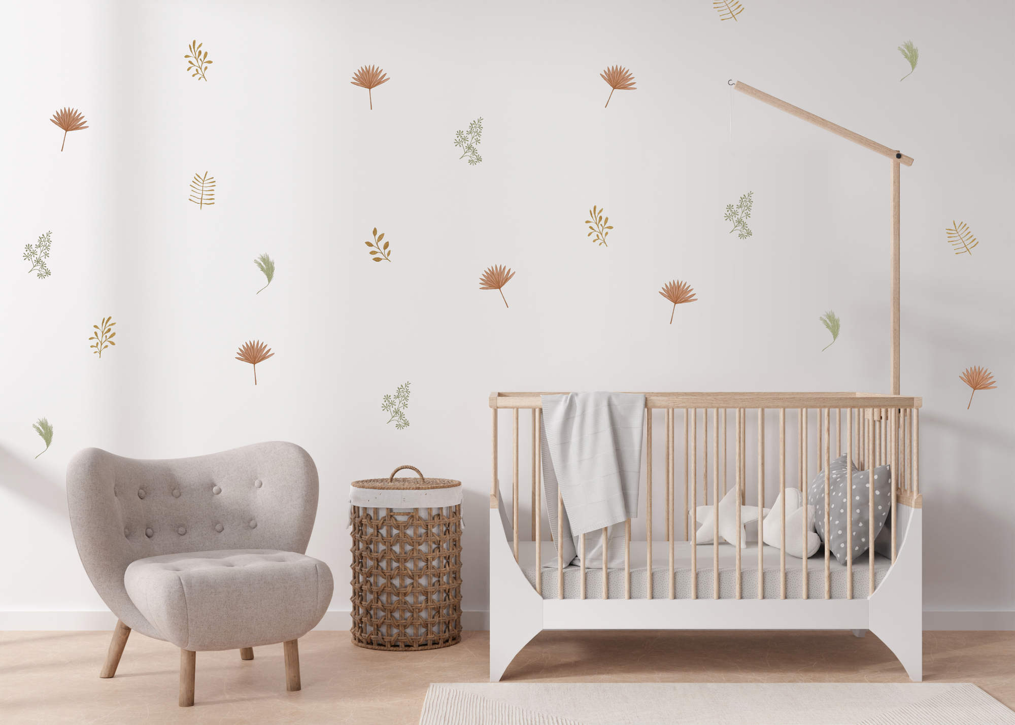 Earthy-tone leaf and flower wall decals arranged on a minimal nursery wall above a crib