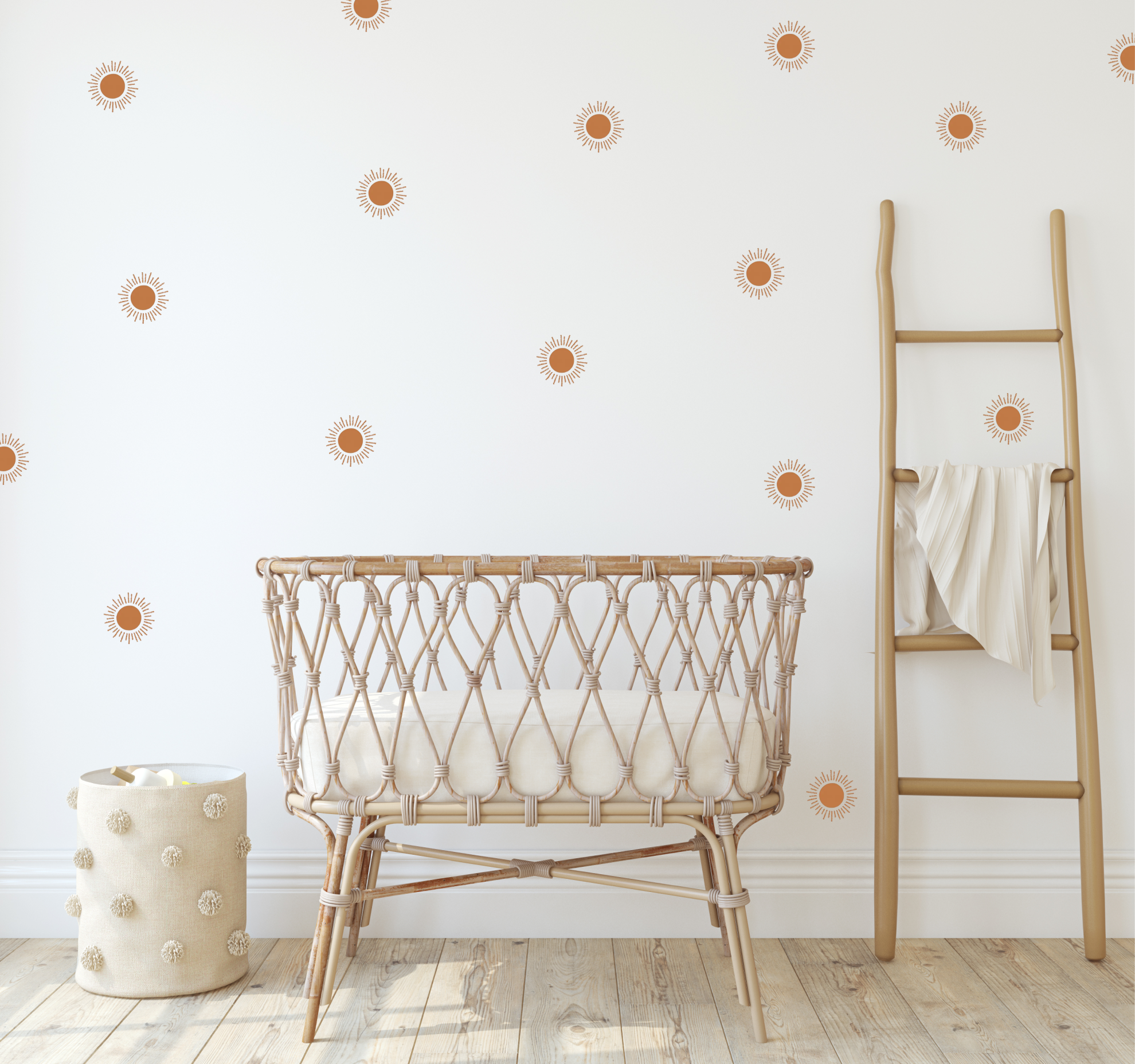 boho nursery with terracotta sun stickers and a canopy over a baby bassinet