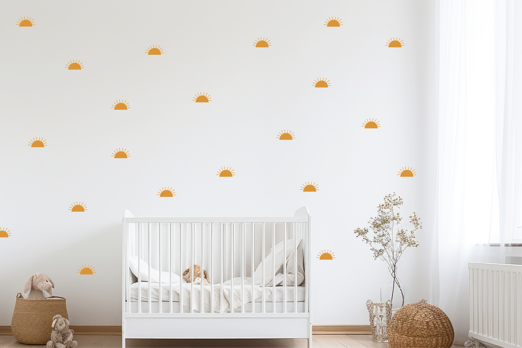 Warm golden sunrise decals arranged on a kids’ bedroom wall behind a white crib and woven toy basket