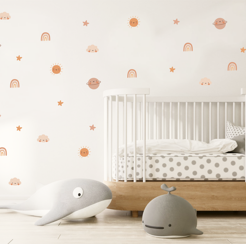 cosmic cuties wall stickers arranged above a baby crib in a neutral nursery
