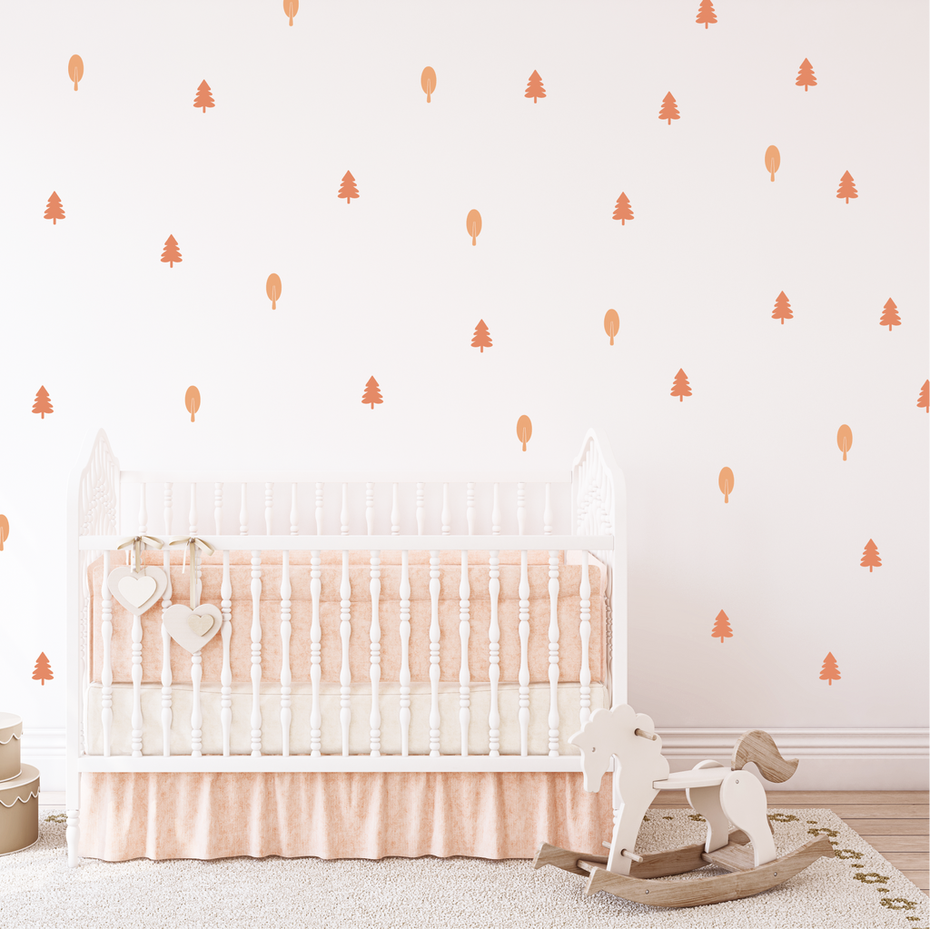 Blush Forest wall stickers styled in a nursery, warm blush trees and shapes above a white crib