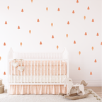 Blush Forest wall stickers styled in a nursery, warm blush trees and shapes above a white crib