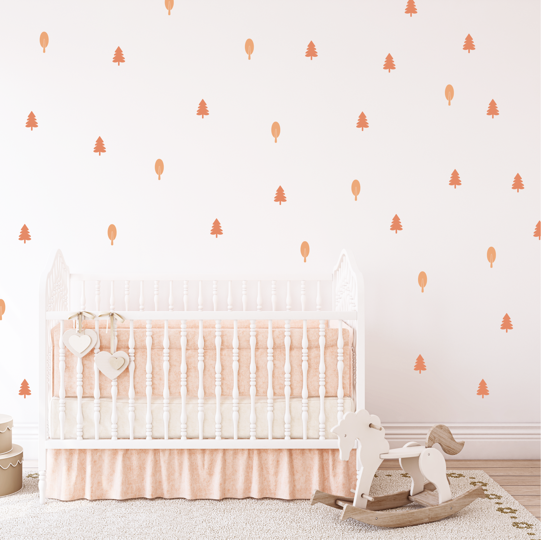 Blush Forest wall stickers styled in a nursery, warm blush trees and shapes above a white crib