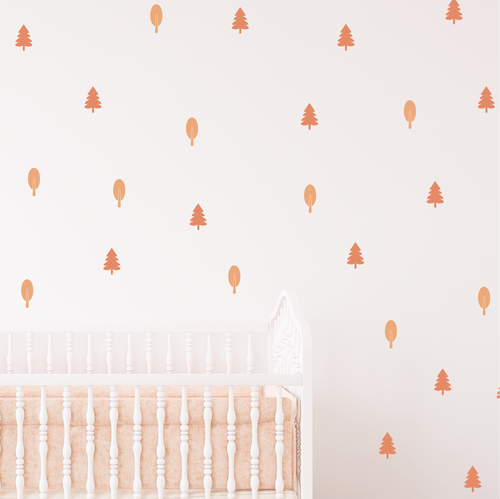 Blush Forest wall decals in blush tones shown above a crib in a minimal kids room decor
