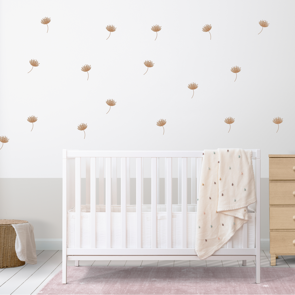 boho kids room with scattered beige flower stickers on the wall behind crib and dresser